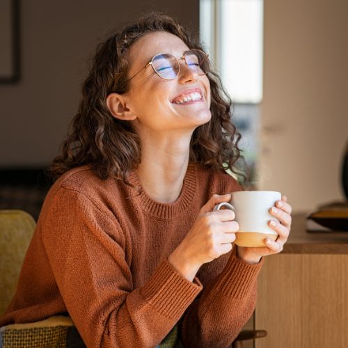 Happy Woman Enjoying Coffee at Home Happy Woman Enjoying Coffee at Home
